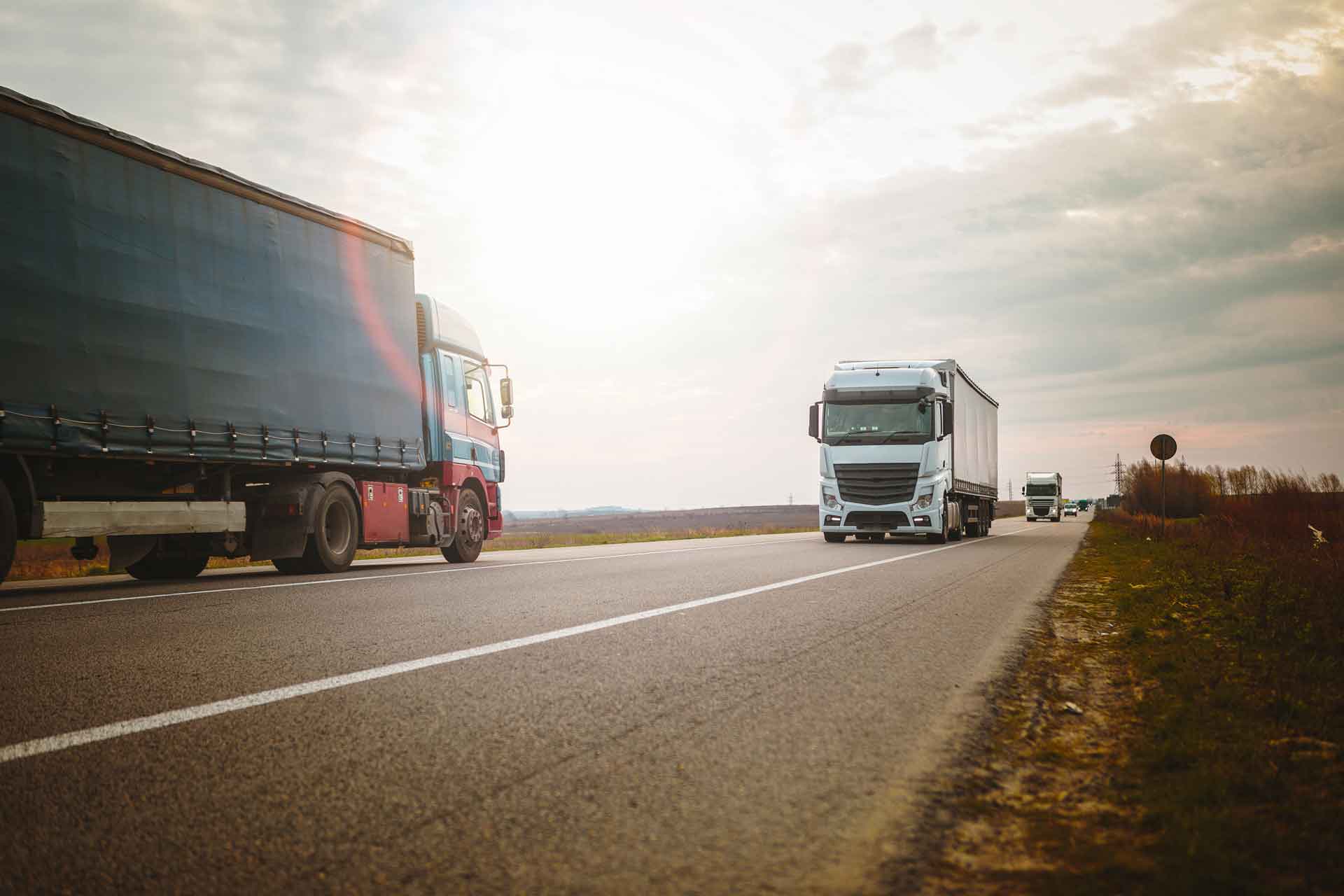 Truck fleet on the highway at dusk